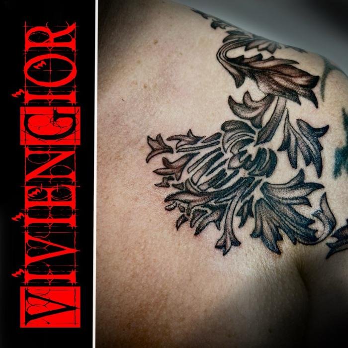 realistic tattoo of black and white flowers spreading across the chest 