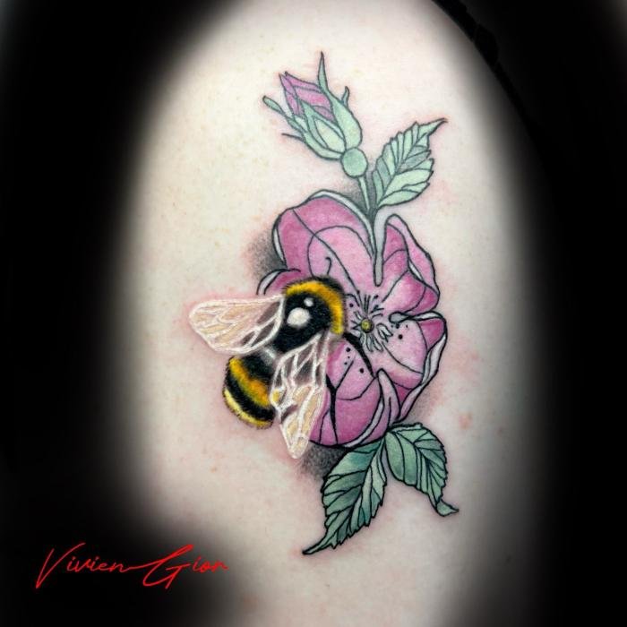realistic tattoo of bumblebee sitting at the flower tattooed on the leg